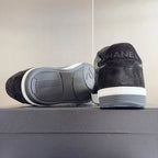 Black Chanel sneakers heel and outsole view, white rubber sole tread