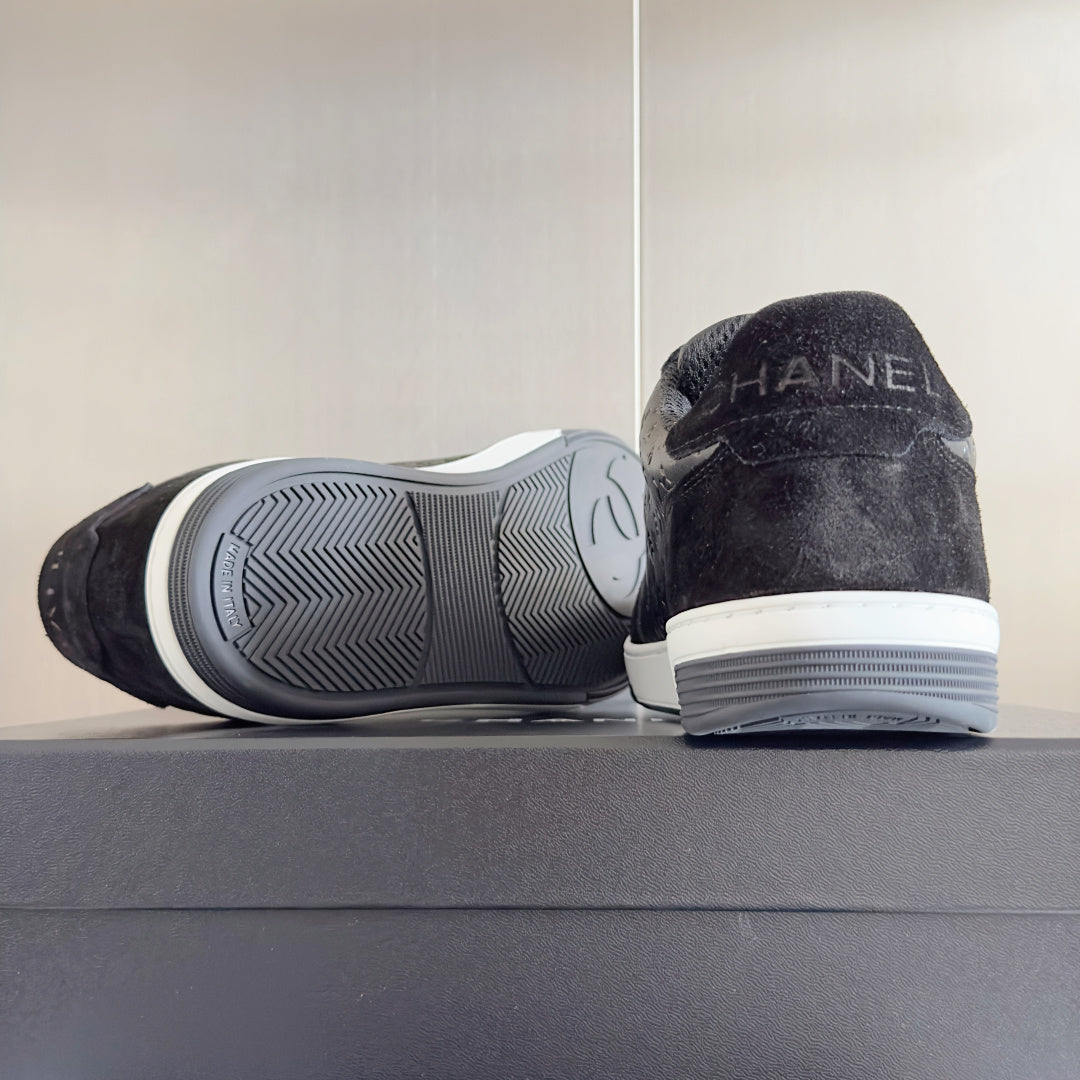 Black Chanel sneakers heel and outsole view, white rubber sole tread