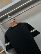 Black short-sleeve T-shirt with green-and-white stripe band on sleeve and upper side