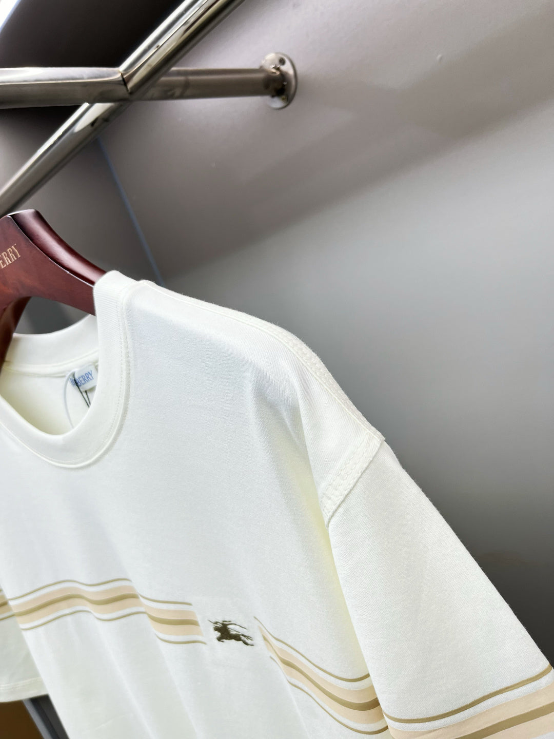 White Burberry T-shirt side view with gold stripe band and small chest logo