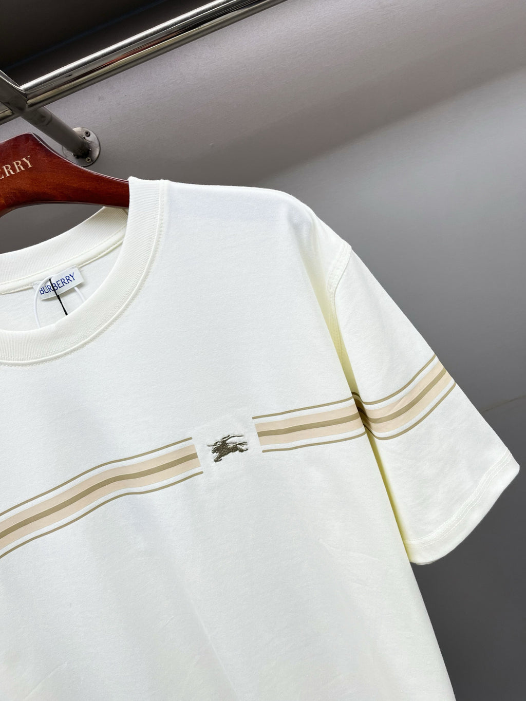 White Burberry T-shirt close-up of gold stripe band and small chest logo