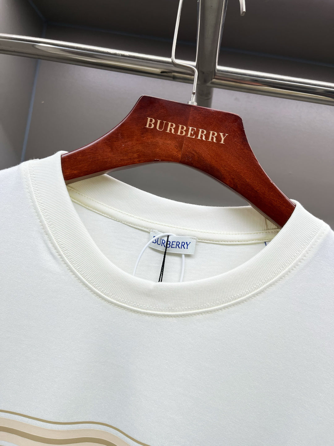 White Burberry T-shirt close-up of ribbed crew neck and gold stripe band