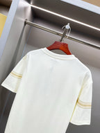 White Burberry T-shirt close-up of back shoulder area and gold sleeve stripe trim