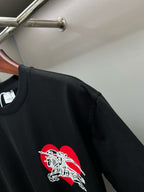Black short-sleeve T-shirt with red and white horse logo near left chest