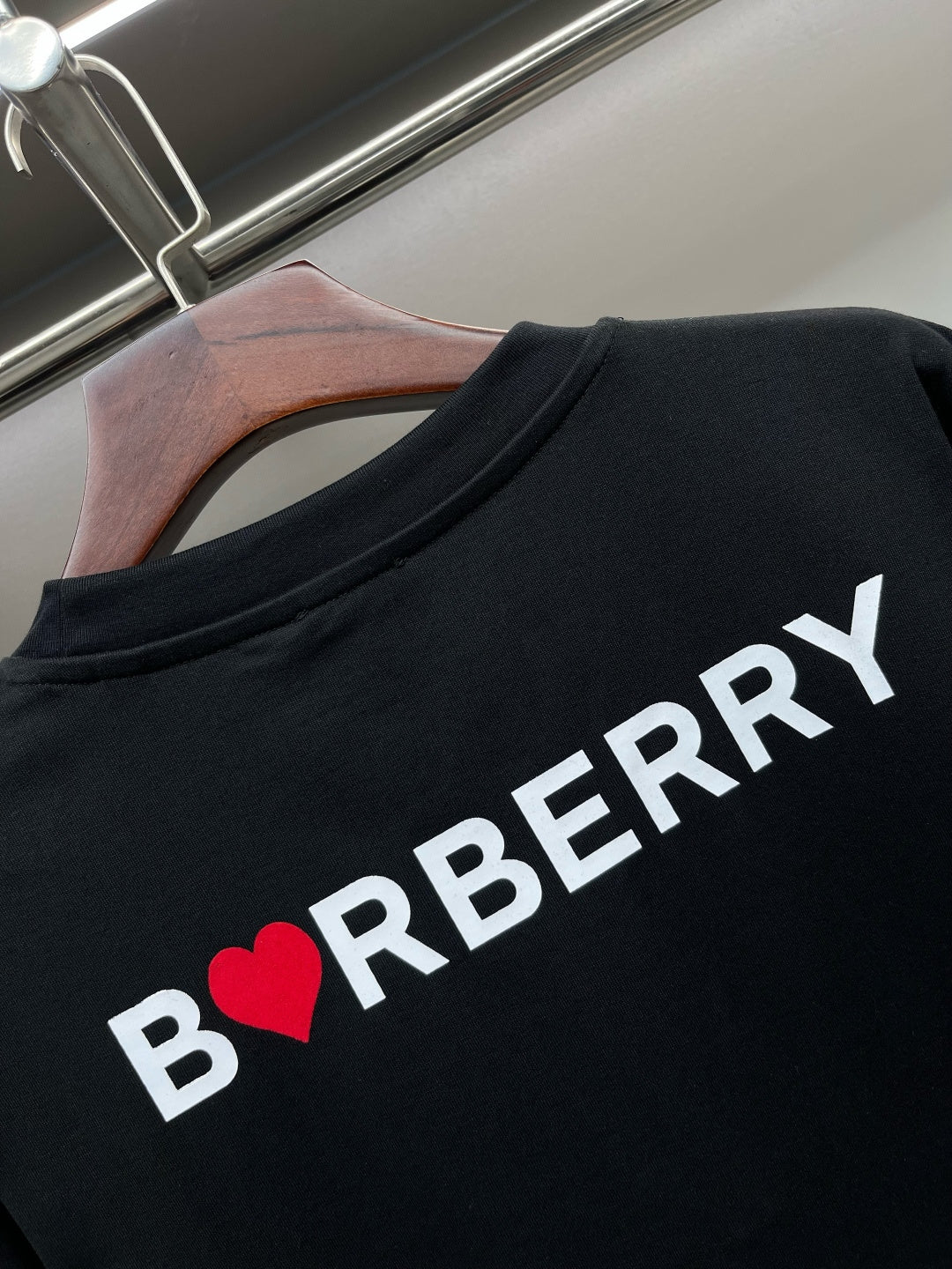 Black T-shirt back with white 'BURBERRY' text and red heart B logo