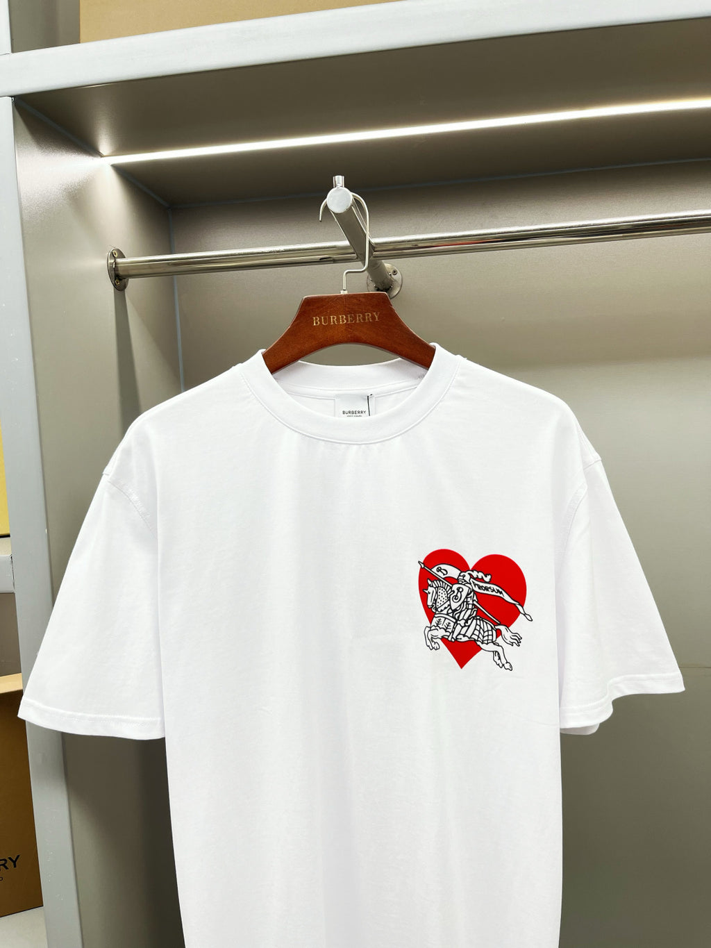 White short-sleeve T-shirt with red knight logo graphic on chest