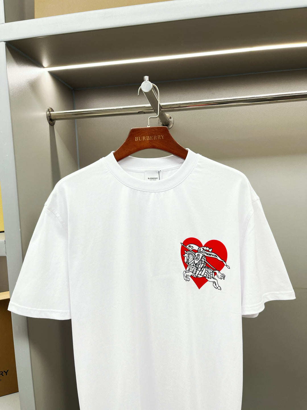 White short-sleeve T-shirt with red knight logo graphic on chest