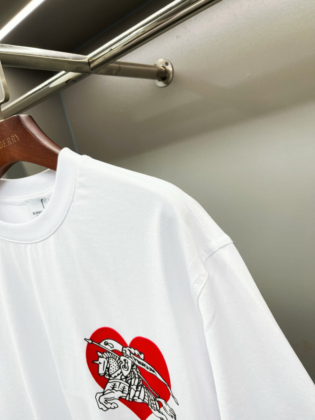 White short-sleeve T-shirt with red knight graphic on left side