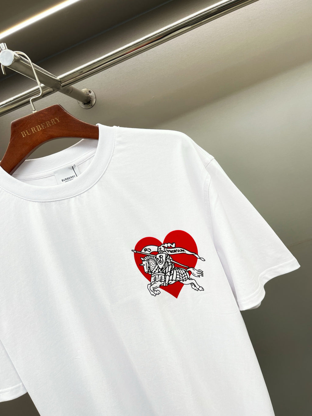 White short-sleeve T-shirt with red and black knight graphic detail