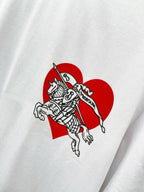 Close-up of white T-shirt with red heart and knight graphic