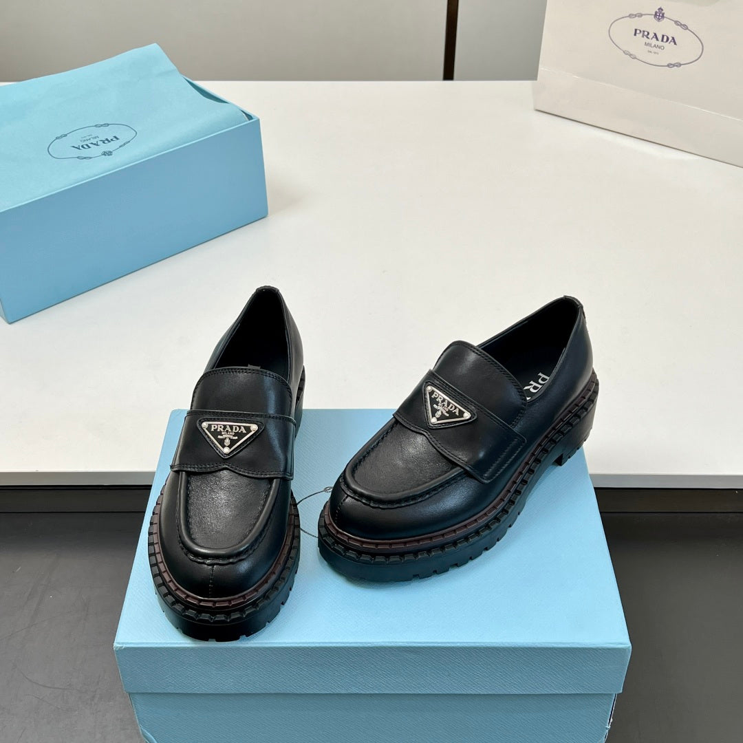 Black Prada unisex loafers, side view with strap and triangular logo