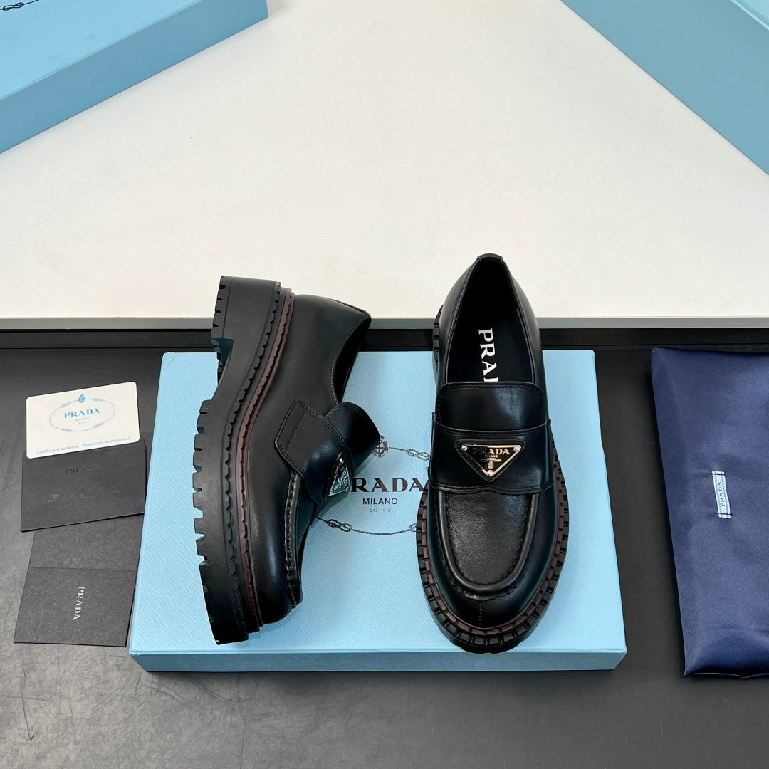 Black Prada unisex loafers, side and heel views showing rugged tread sole