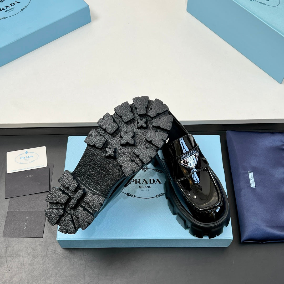 Black loafer outsole with deep lug tread, platform base and glossy upper
