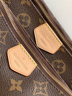 Louis Vuitton monogram bag close-up of zipper and leather logo patch