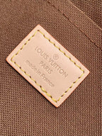 Louis Vuitton Paris leather label patch on brown fabric, stitched edges