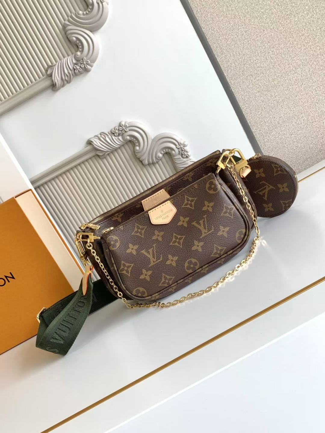 Louis Vuitton monogram crossbody bag with gold chain strap and zipper closure