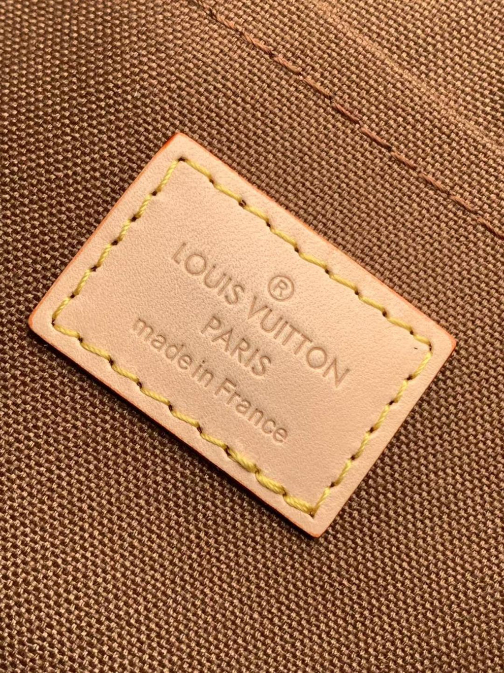 Louis Vuitton made in France leather logo label on monogram bag