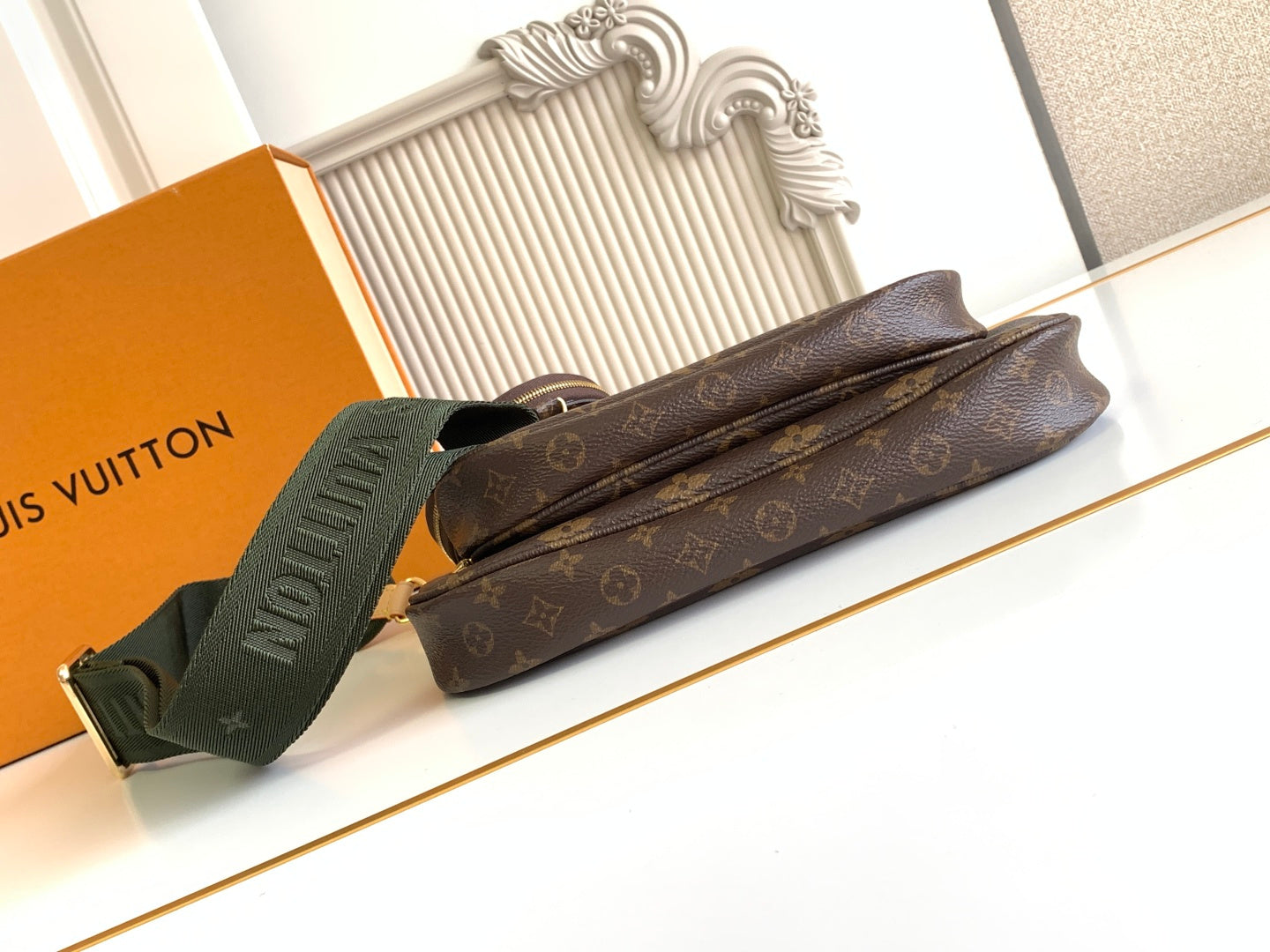 Louis Vuitton monogram pouch bag with green web strap and zipper closure
