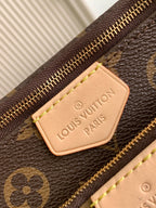 Louis Vuitton monogram bag with leather logo patch and gold zipper detail