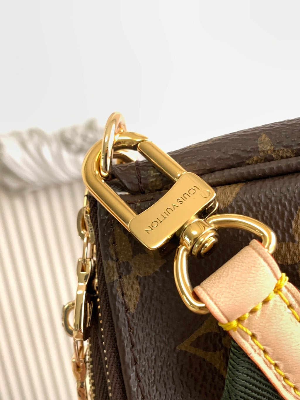 Louis Vuitton monogram bag with gold hardware ring and green web strap