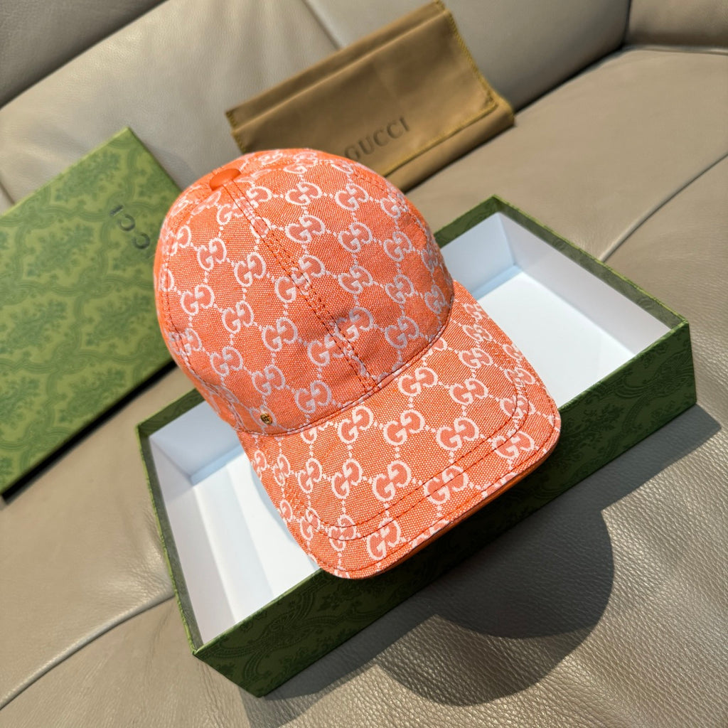 Orange GG monogram baseball cap with curved brim and stitched seam details