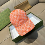 Orange GG monogram baseball cap with curved brim and stitched seam details