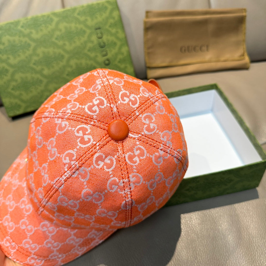 Orange GG monogram baseball cap with round button detail on the crown