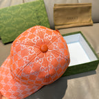 Orange GG monogram baseball cap with round button detail on the crown