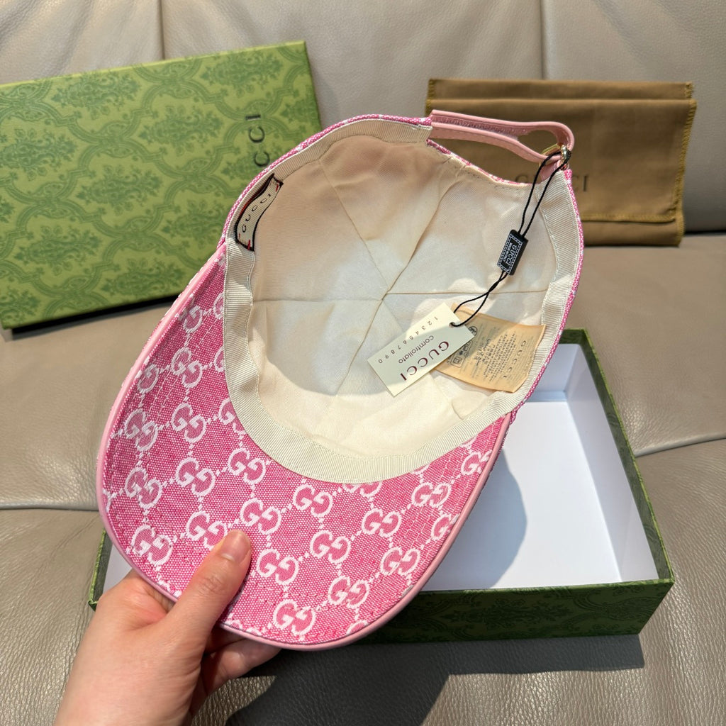 Pink GG-print cap interior with beige lining and adjustable chin strap.