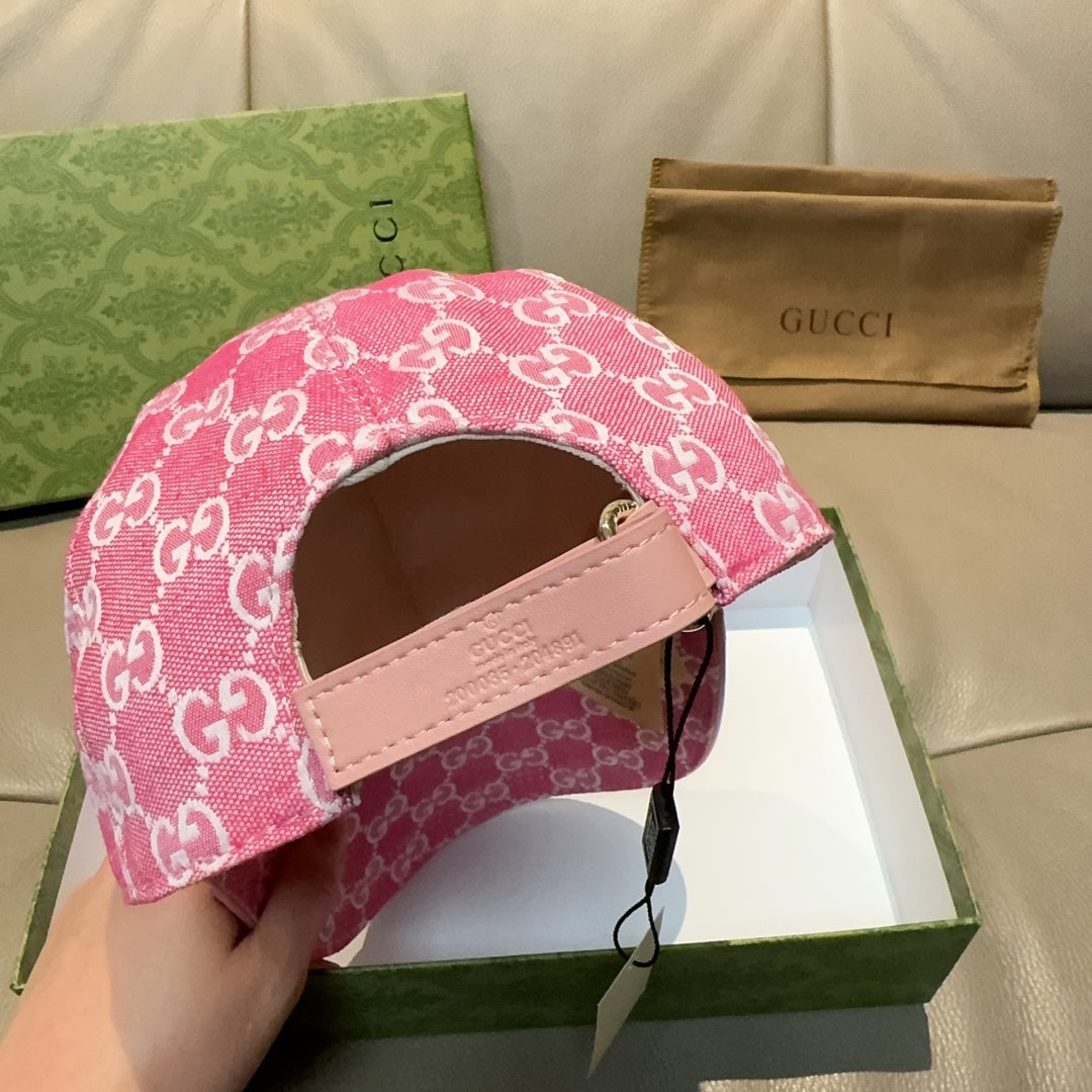 Pink GG-print cap showing side opening and adjustable leather strap.