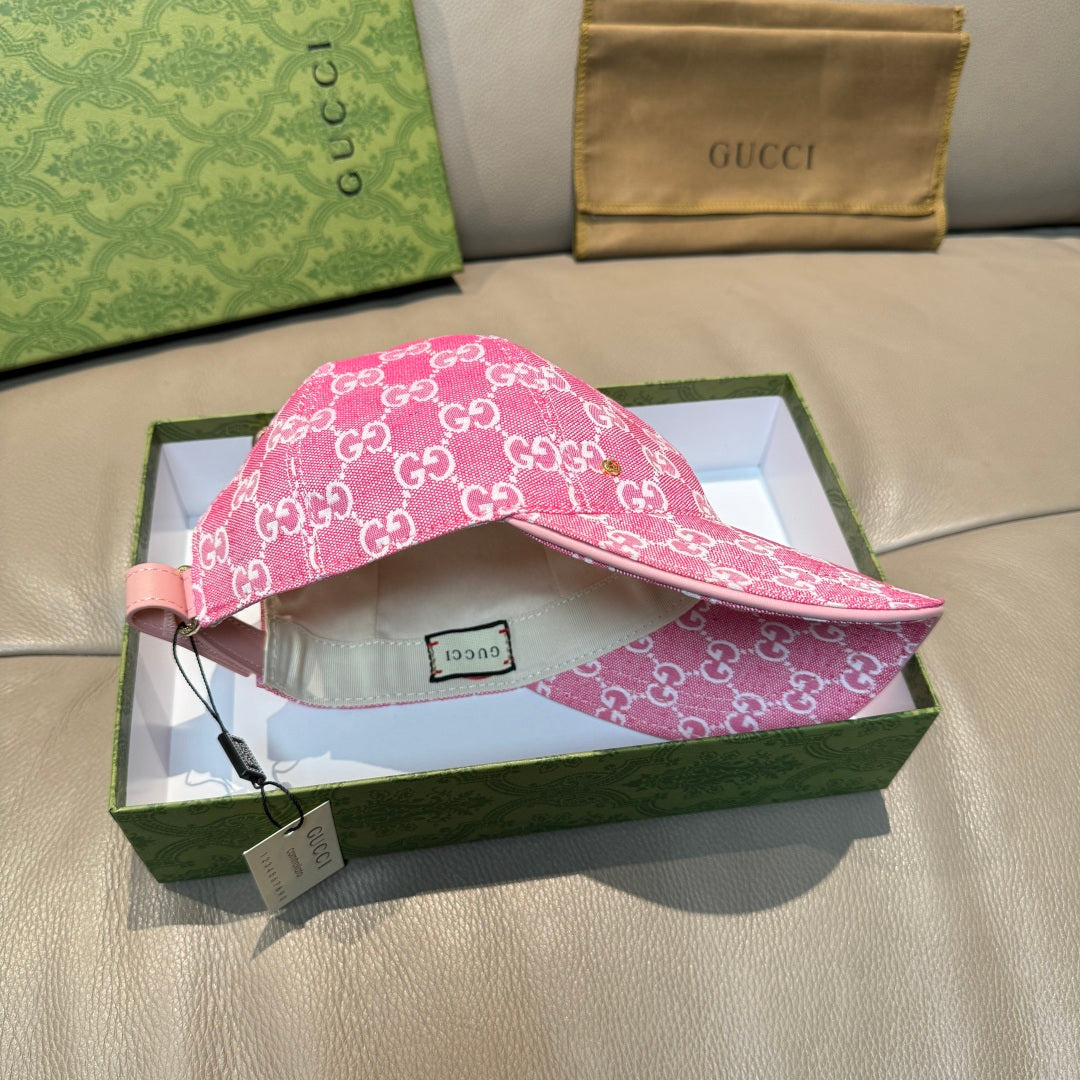 Pink GG-print cap with adjustable strap and interior size label visible.