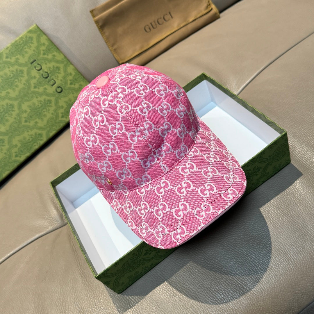 Pink GG-print baseball cap with curved brim and small front button.