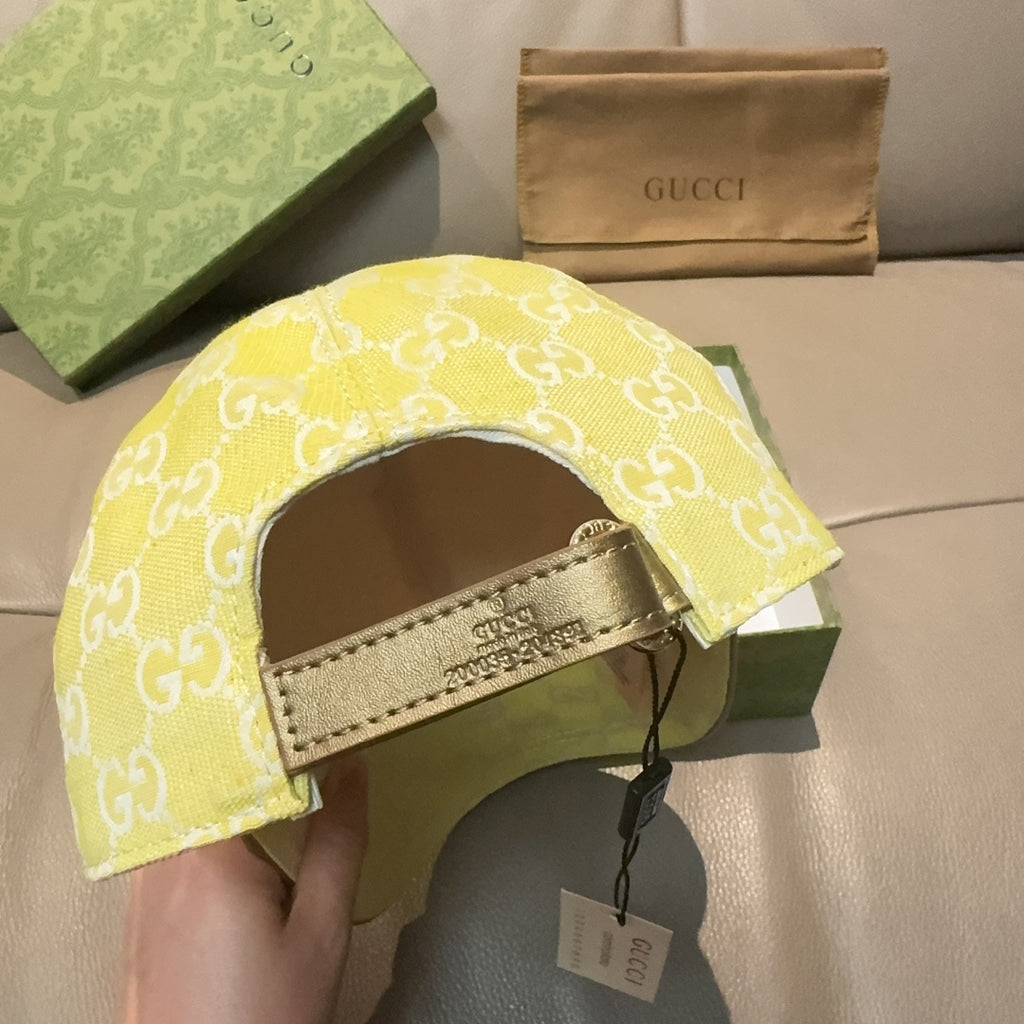 Gucci cap yellow with white GG monogram, inner strap and hanging tag visible