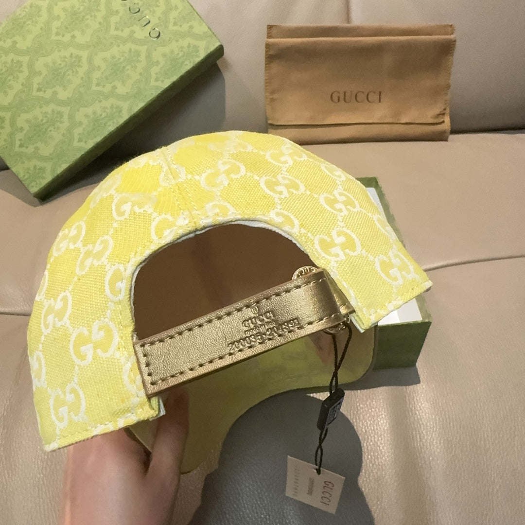 Gucci cap yellow with white GG monogram, inner strap and hanging tag visible