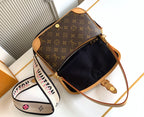 Monogram canvas crossbody bag with open top, black interior, and gold zipper hardware