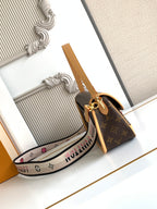 Monogram canvas satchel with tan strap and multicolor logo print shoulder strap