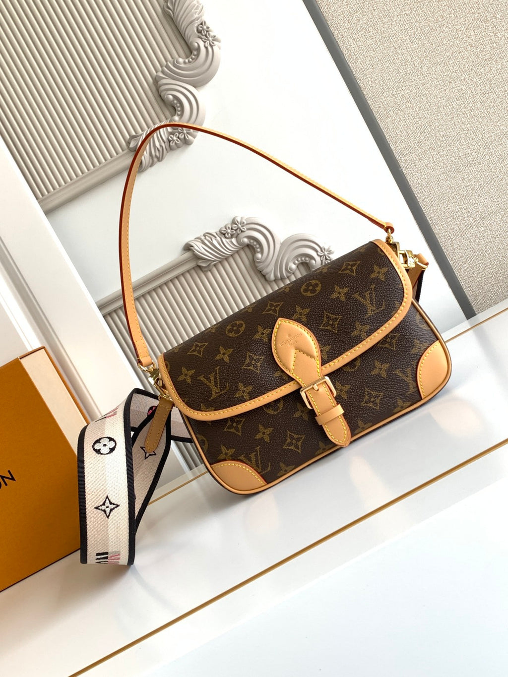 Monogram canvas shoulder bag with tan leather trim and front flap, gold clasp