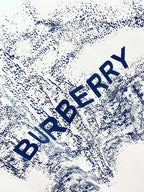 White T-shirt close-up of blue Burberry logo text splash print
