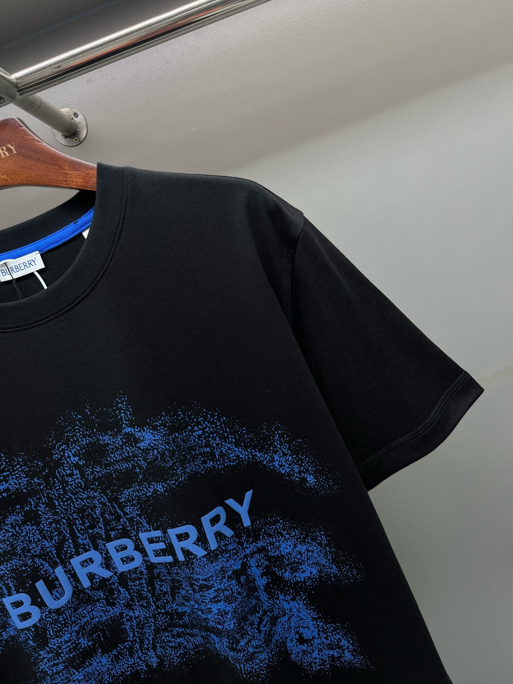 Black Burberry T-shirt with blue logo graphic text on sleeve