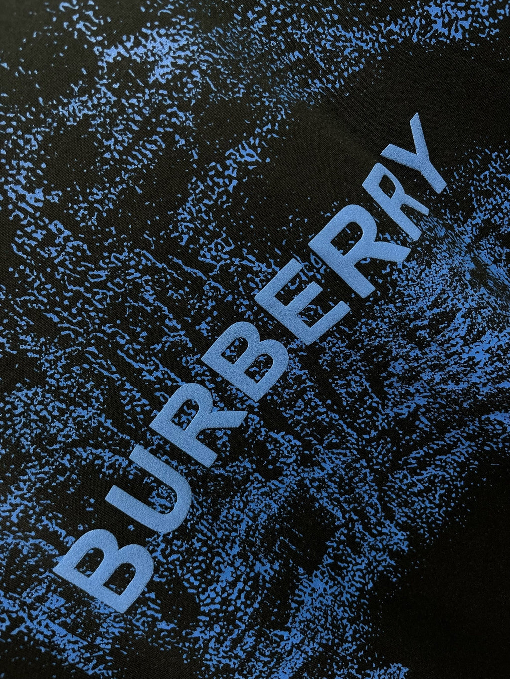 Blue Burberry logo text on black T-shirt