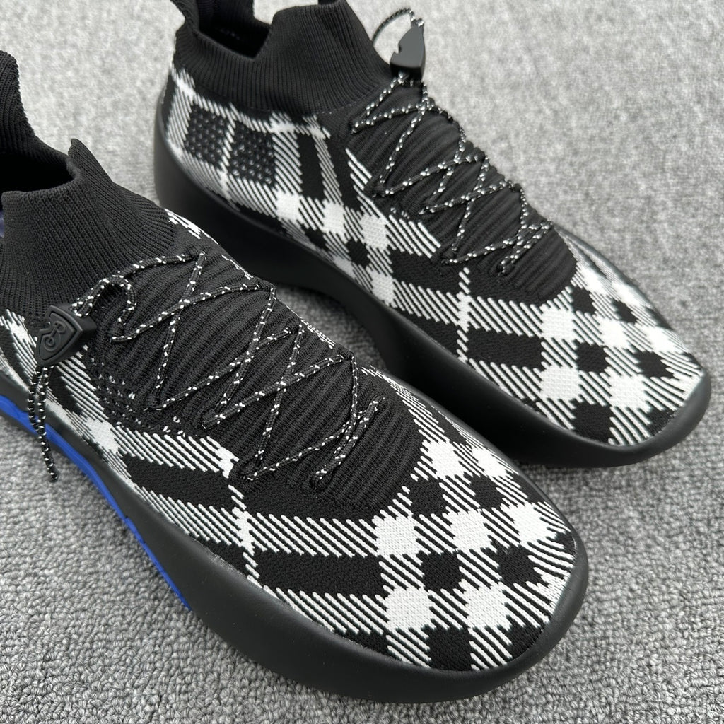 Black and white plaid knit sneakers with braided laces and blue sole trim