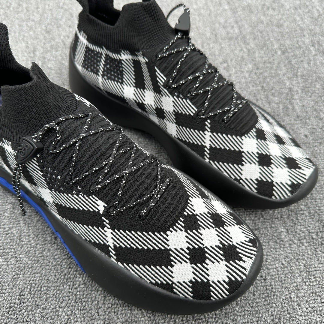 Black and white plaid knit sneakers with braided laces and blue sole trim