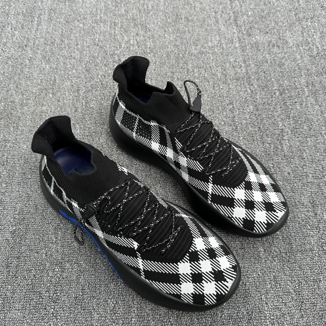 Check knit sneakers in black and white plaid with lace-up front and blue accent