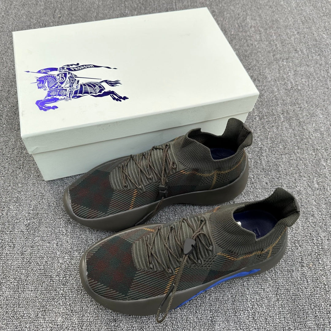 Pair of plaid knit sneakers with blue sole accents and lace-up design
