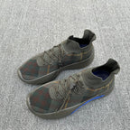 Pair of lace-up plaid knit sneakers with navy lining and blue side stripe