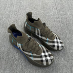 Lace-up sneakers with olive knit upper, black-and-white plaid panels and blue trim
