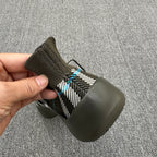 Heel view of olive sneaker with black-and-white plaid knit and blue thread accents
