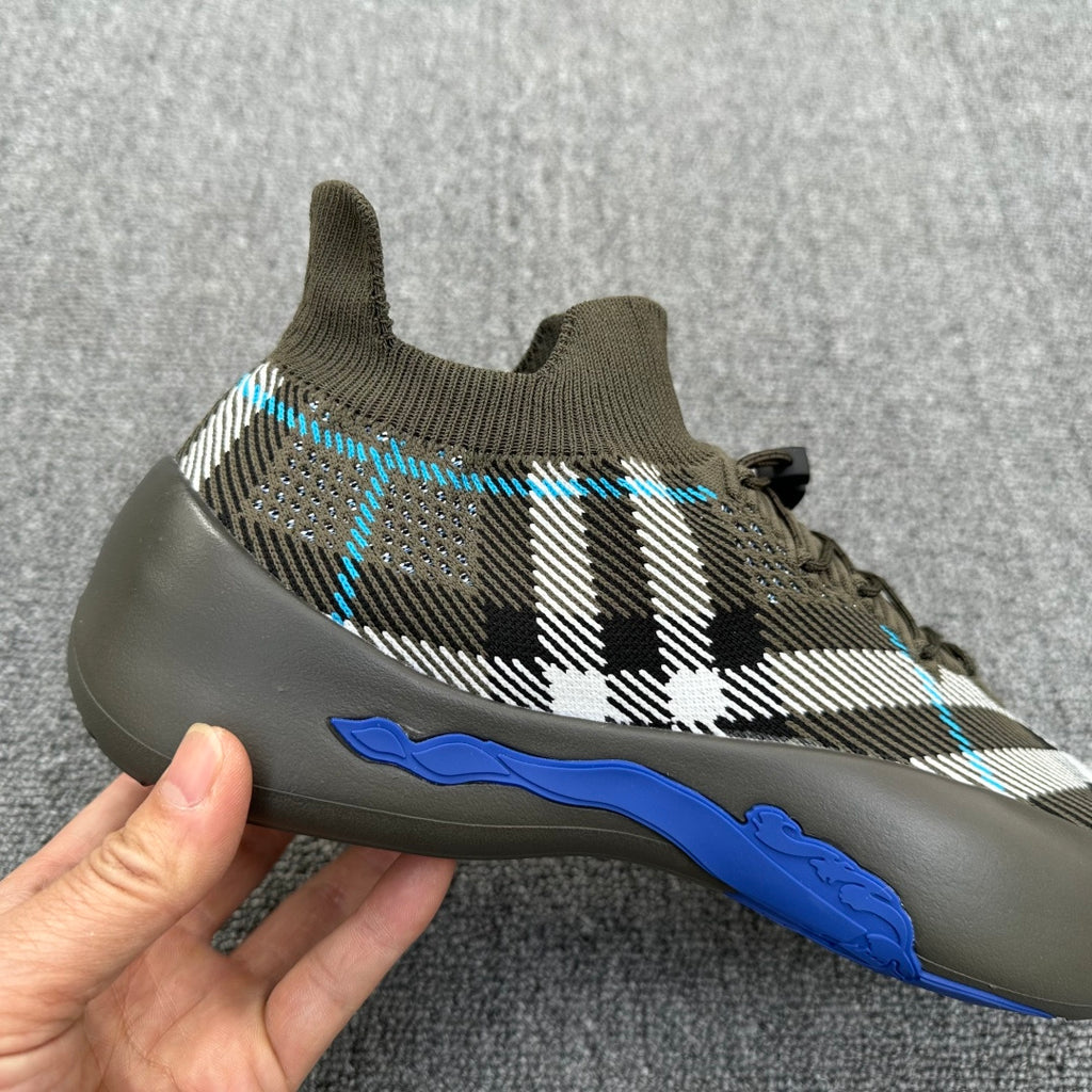 Olive lace-up sneaker with black-and-white plaid knit and blue outsole stripe