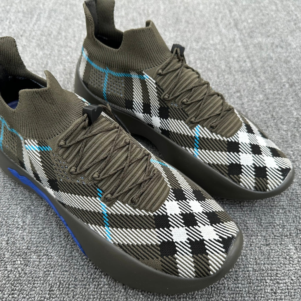 Olive sneakers with black-and-white plaid knit and blue stitching accents