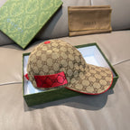 Gucci baseball cap with GG monogram fabric, red interior patch, and curved brim.